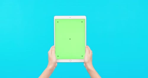 Person, hands and tablet on mockup with green screen for social media advertising against a blue