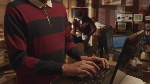 Software Engineer Using Laptop in Old School Garage Office