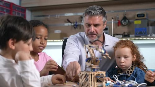 Enthusiastic Teacher Explains How to Build a Robot