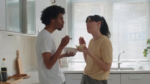 Young Couple Enjoying a Meal Together in Kitchen