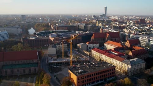 Aerial Flying Over Construction Cranes In Wroclaw City Centre. Dolly Forward