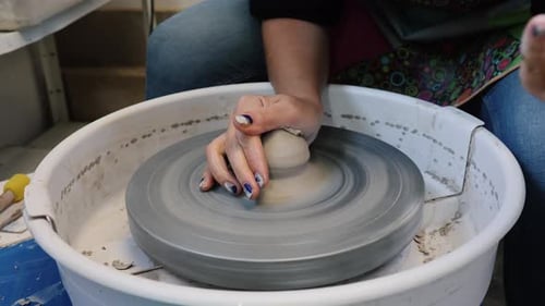 Hands Shaping Clay on Spinning Pottery Wheel