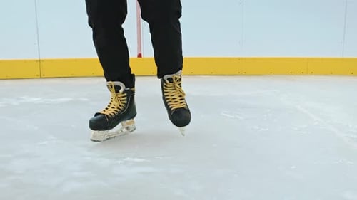White ice on river lake in park. Legs of man in skates on ice.