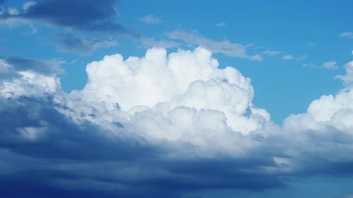 Fluffy White Clouds Against a Clear Blue Sky