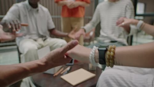 Adults Joining Hands Together in Circle