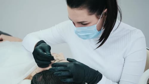 Cosmetologist Making Eyebrow Permanent Makeup
