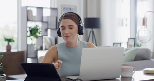 Woman Listens to Music Working on Laptop at Home