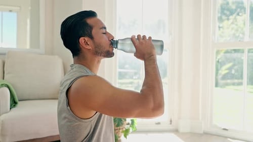 Athletic Man Drinks Water After Exercise