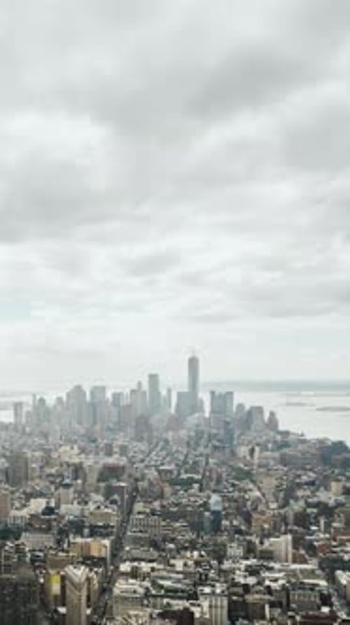A High View of Manhattan with Clouds Quickly Drifting Over the Skyscrapers As the Camera Smoothly