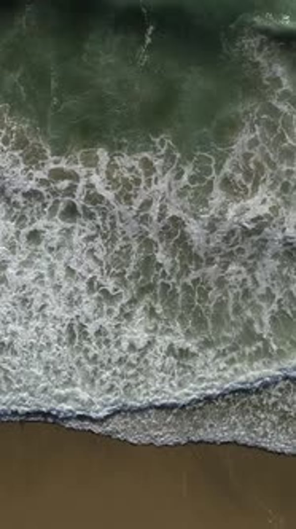 Foamy waves roll to the sandy beach and rocks at the coast. , Nature ...