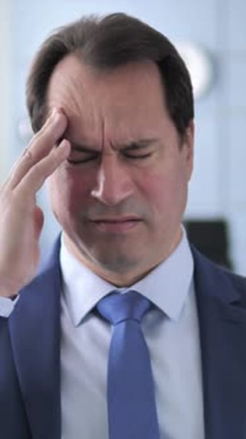 Man in Suit Experiencing Headache, Stress, and Migraine
