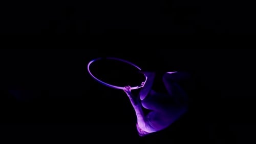 Woman Doing A Split Under The Bar Of An Aerial Hoop