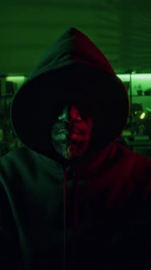 Hooded Figure in the Dark in Green Light