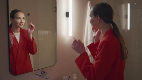 Woman Applies Makeup in Modern Bathroom