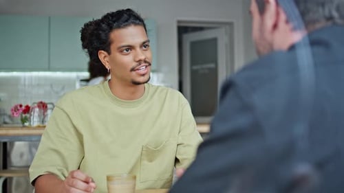 Two Male Friends Talking in Cafe Close Up Multiracial Men Speaking Together