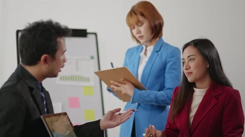 Three Colleagues Meeting to Plan Strategy in Workplace