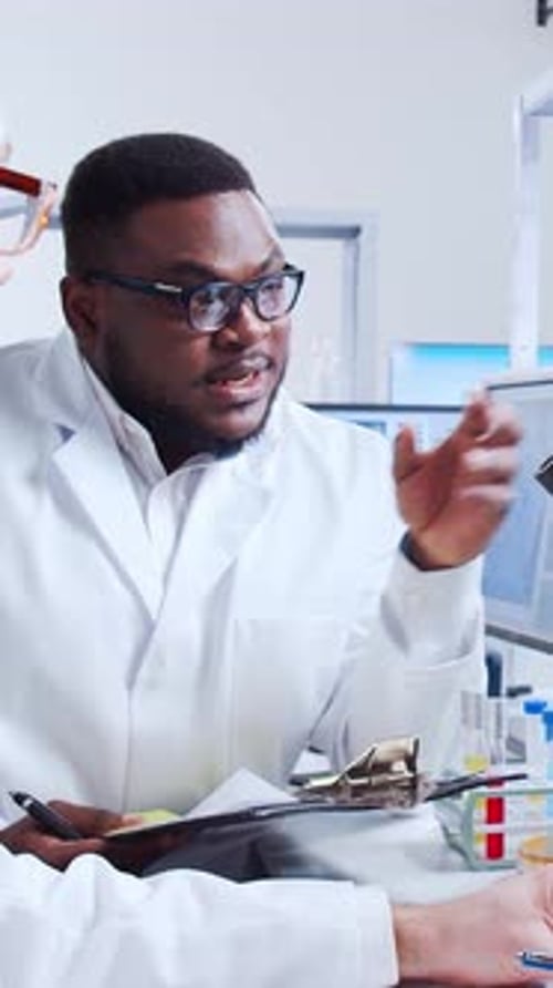 Scientists Discussing Lab Results in Bright Laboratory