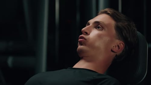 Man Doing Leg Press Exercise in Gym