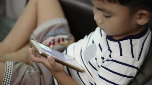 Child Using Smartphone Indoors