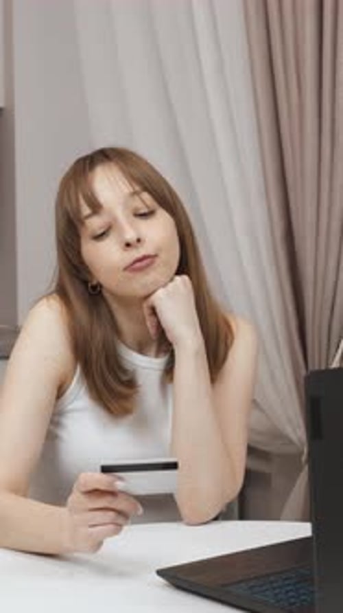 Woman making online payment with credit card at home