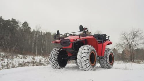 Offroad Vehicle Testing in Winter Snowed Field with ATV and Rider Testing Traction Exploring Winter