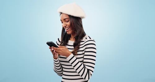 Phone, smile and woman in a studio typing message on social media, mobile app or the internet