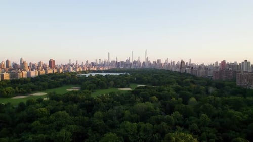 Beautiful aerial dolly shot of Central Park at sunset, NYC