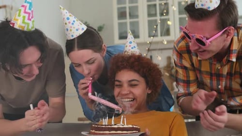 Friends Celebrating Birthday With Cake and Party Horns