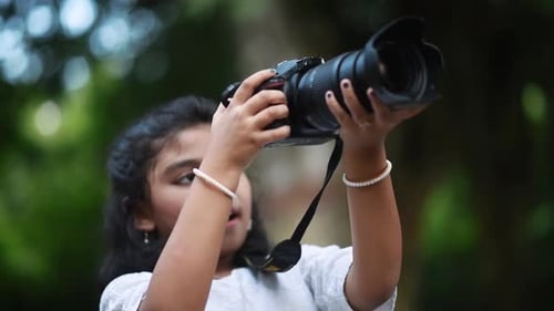 Girl Taking Pictures with DSLR Camera Outdoors