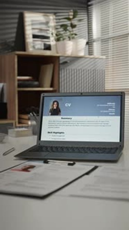 Laptop Displaying Resume on Desk in Home Office