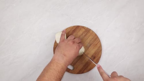 Top view of cutting onions on the wooden board