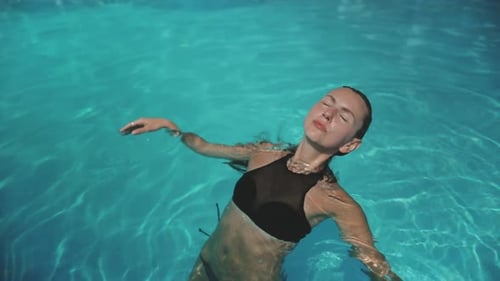 Beautiful Woman Relax in Swimming Pool