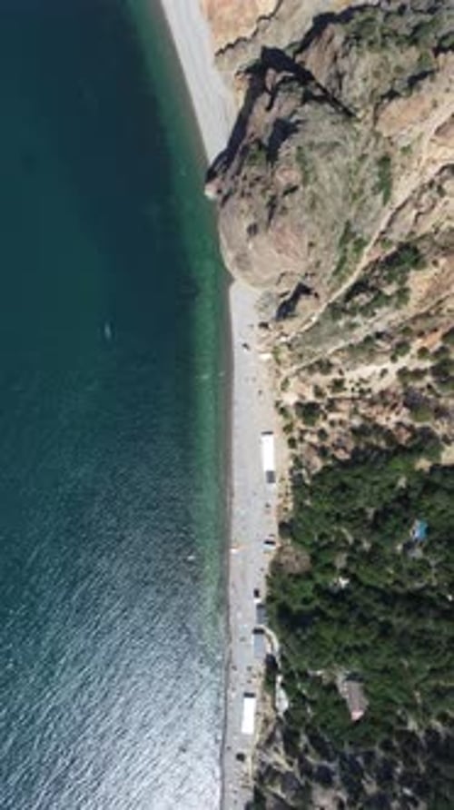 Aerial View From Above on Calm Azure Sea and Volcanic Rocky Shores Small Waves on Water Surface in