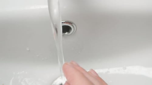 Washing Hands with Water in Clean Sink