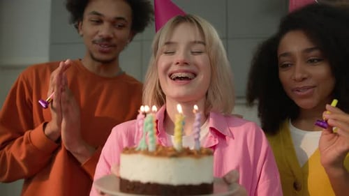 Young Adults Celebrate Birthday Blowing out Candles