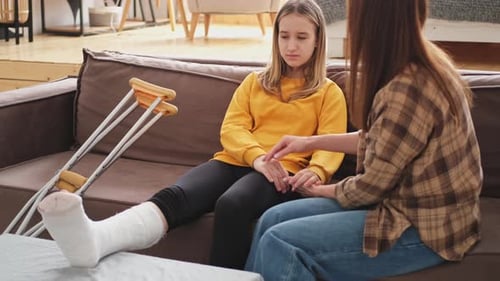 Teenage Girl with Broken Leg Receives Comfort at Home