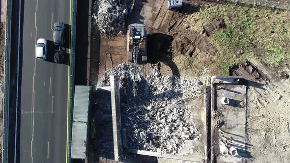 Push in shot of rubble at a construction site next to a highway ...