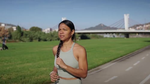 Slow Motion of Latina Young Fit Woman Running in a City Urban Park Female Effort Workout