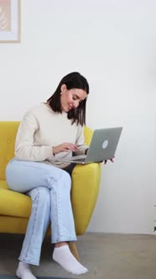 Young Adult Working on Laptop on Couch