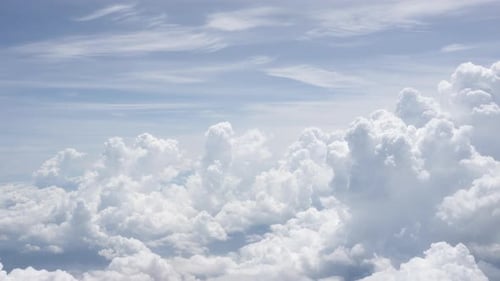 View of clouds in the blue sky from plane porthole