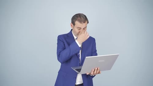 Man Works on Laptop Computer in the Office