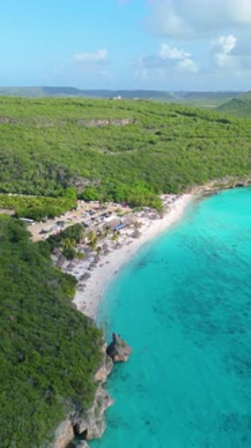Vertical slow orbit drone shot of rocky coastline at Cas Abao