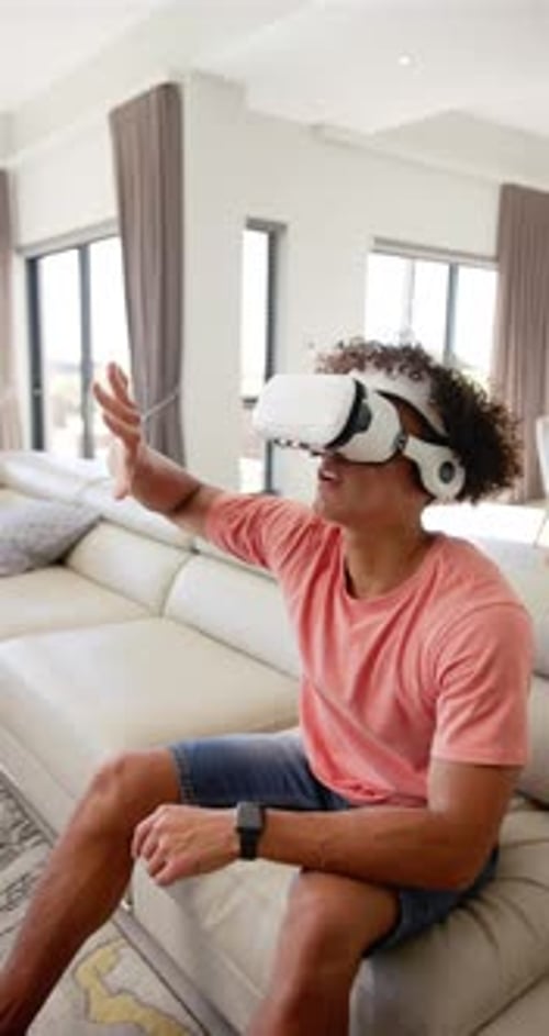 Young Adult Using Virtual Reality Headset at Home
