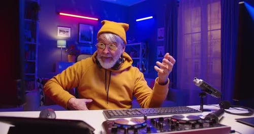 Senior Man Mixing Music at His Home Studio
