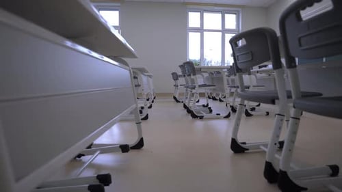 Empty Desks and Chairs in School Classroom
