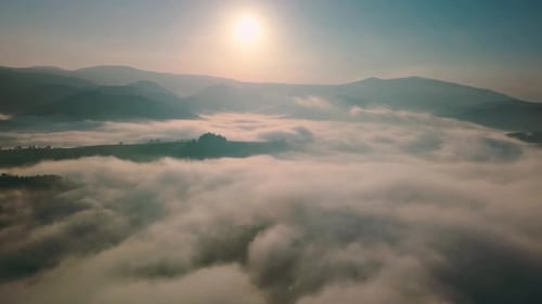 Aerial View of Foggy Mountain Landscape at Sunrise