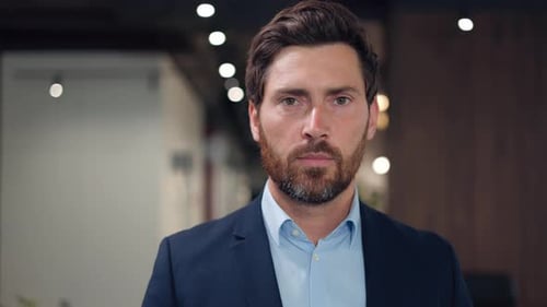Portrait of Severe Bearded Man Standing on Background of Personal Office