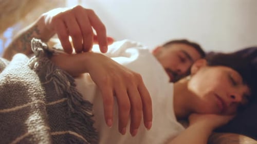 Loving Couple Resting Together in Bed