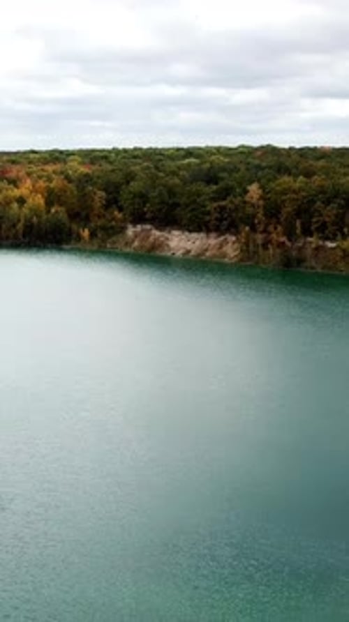 Aerial view over lake. Aerial view of forest with lake landscape. Vertical video