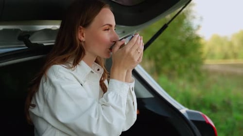 Mental Health and Privacy in Nature Relaxing Alone a Young Woman Drinks Coffee While Relaxing in the